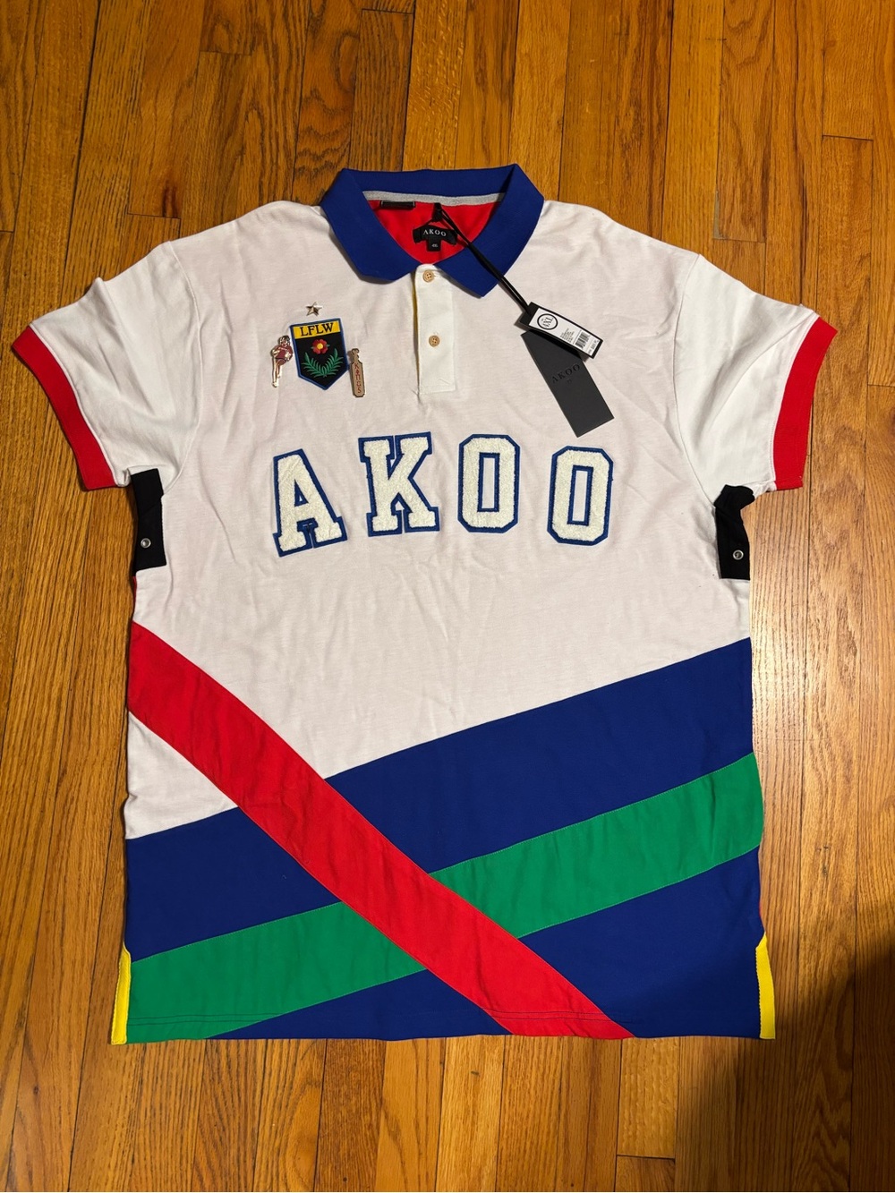 Akoo White Polo with Blue Trim and Embroidered Patch